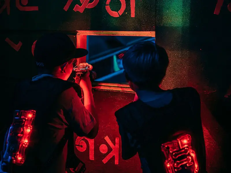 Children playing laser tag in neon light